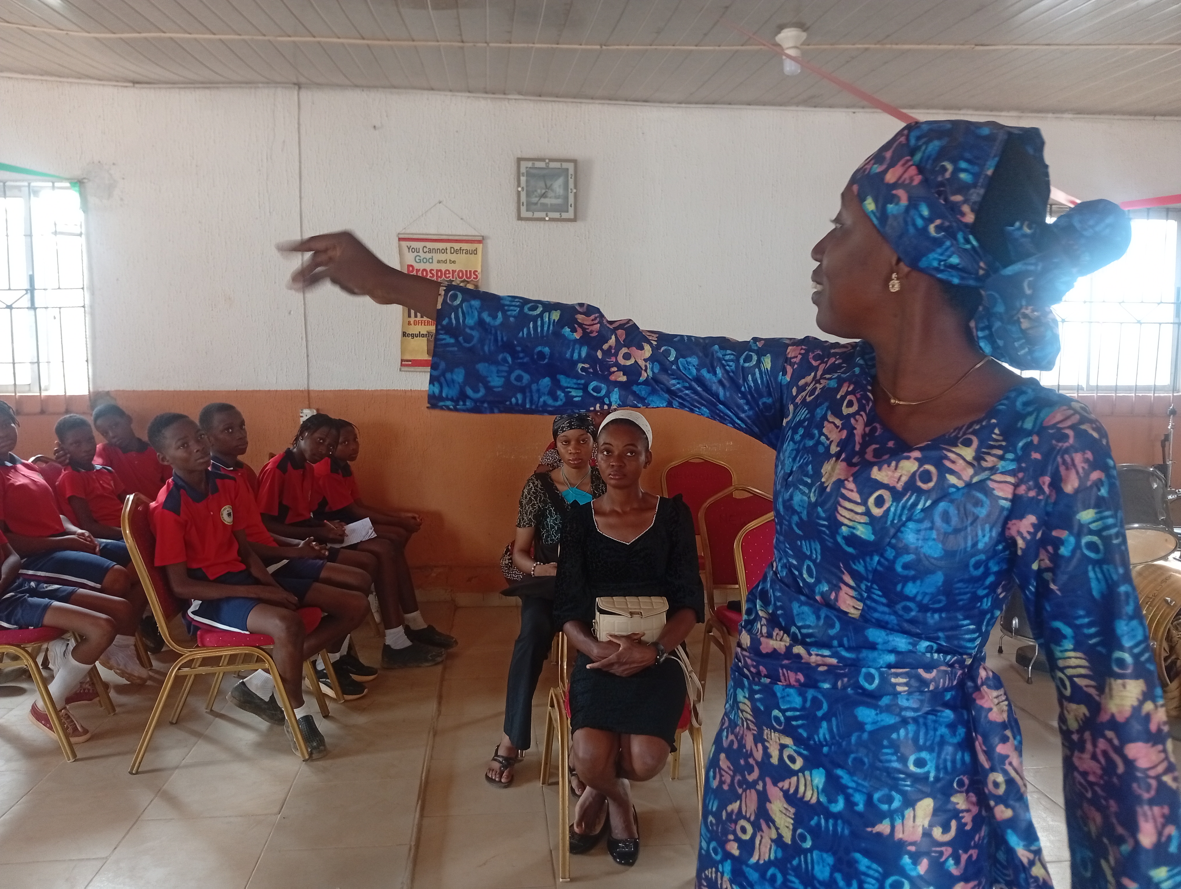 A mentor teaching students during an indoor outreach